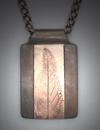 Pendant - Bronze leaf inlay on White Satin blackened with patina; 1 ½” x 1”