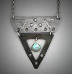 Steel V Pendant - Labradorite;  L=  2”   W= 1 3/4”;  Hand sculpted steel pendant.   Triangle shaped, 2 piece steel within which hangs a 8x9mm Labradorite briolette gemstone.  Hangs on a 24” chain.