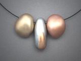 “3 Hollow Forms – 2”;  Bronze, Copper & Steel hollow forms necklace on Memory Wire. 3 beads together measure 2 ½” w & center bead is 1 ½” h.