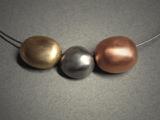 “3 hollow beads”; necklace; 1 bronze, 1 steel & 1 copper together measuring 2 ½”w x ½”h.